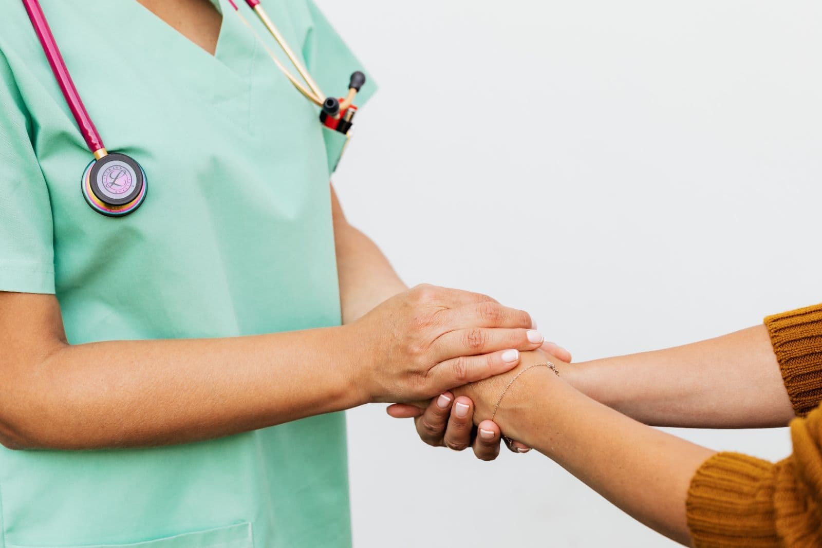A nurse holding a client's hands